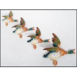 A good set of four 20th century Beswick wall plaques in the form of flying mallards  ( ducks )