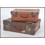 A vintage 20th century full grain leather suitcase with dual brass lock with notation for