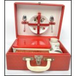 A vintage retro 20th century Brexton portable picnic hamper set in a red vinyl case with fitted