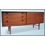 A 1970's Danish inspired retro sideboard raised on tapering legs having a bank of three drawers to