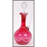 A believed 19th century Victorian cranberry glass dimpled decanter with the clear glass stopper in