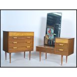 A retro 1960's teak wood dressing table and chest of drawers combination bedroom set each being