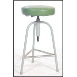 A vintage mid 20th century retro industrial machinist stool by Shaw of tubular construction raised