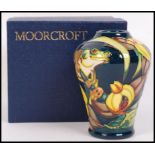 A Moorcroft ceramic tube lined vase decorated in the Amazon Collection pattern with impressed