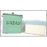 A retro 1950's green enamel bread bin having central notation with lid together with a 1980's