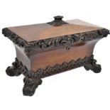 A 19th century rosewood over sized tea caddy of sarcophagus form having a concave body raised on s