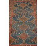 A 19th century handwoven Kurdish small rug with geometric designs having a run of central medallions