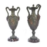 A pair of 19th century spelter painted twin handled urns raised on rouge marble plinth bases. The