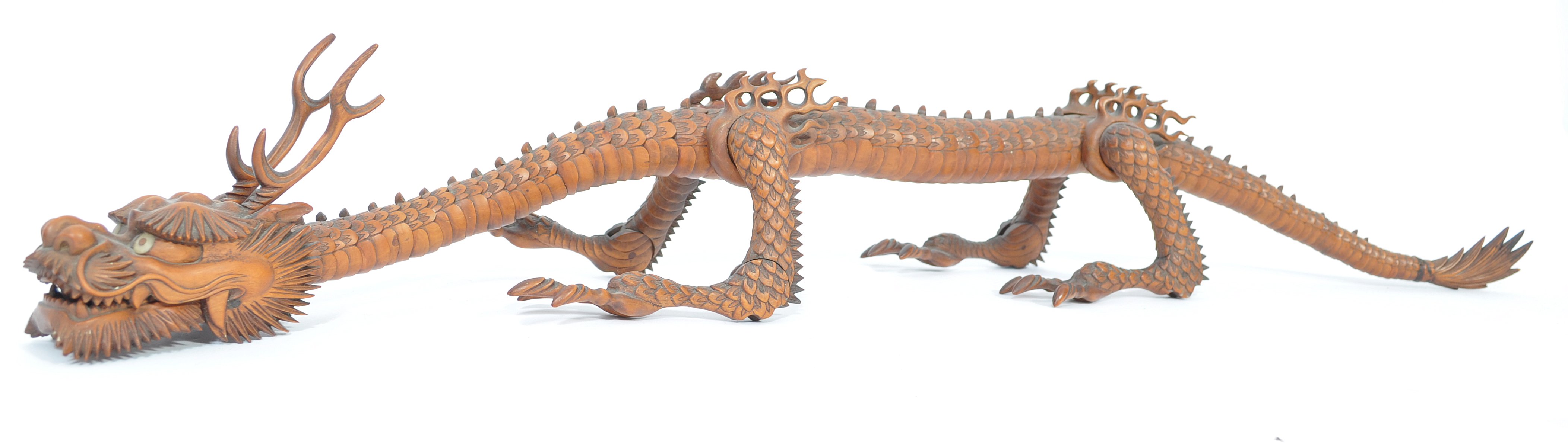 A Japanese carved and articulated wooden dragon Meiji period (1868-1912), probably boxwood, the body