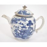 An 18th century Chinese blue and white teapot in the willow pattern. The teapot with scene of