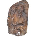 A 16th century Renaissance period limewood carving wall plaque mask carved in relief depicting a