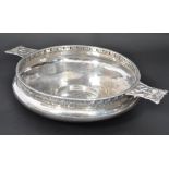A silver hallmarked A. E. Jones silver Arts and Crafts twin handled bowl, of compressed form with