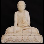 A 19th century Ivory Thia buddha deity carved sculpture seated on a flat pedestal with swag