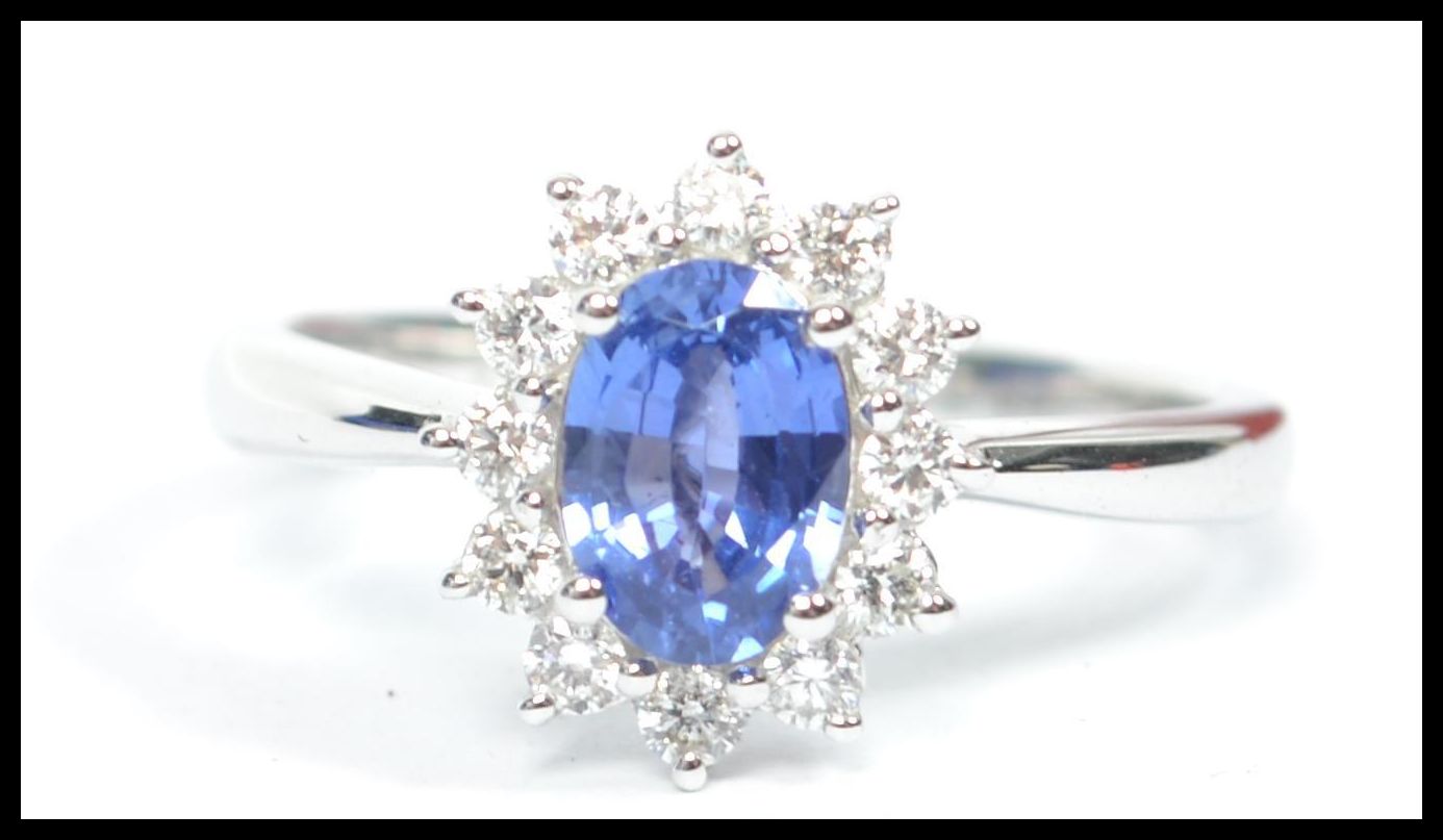 An 18ct white gold sapphire and diamond halo clust