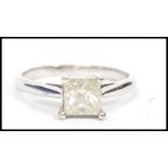 A white gold single stone diamond ring. Princess c