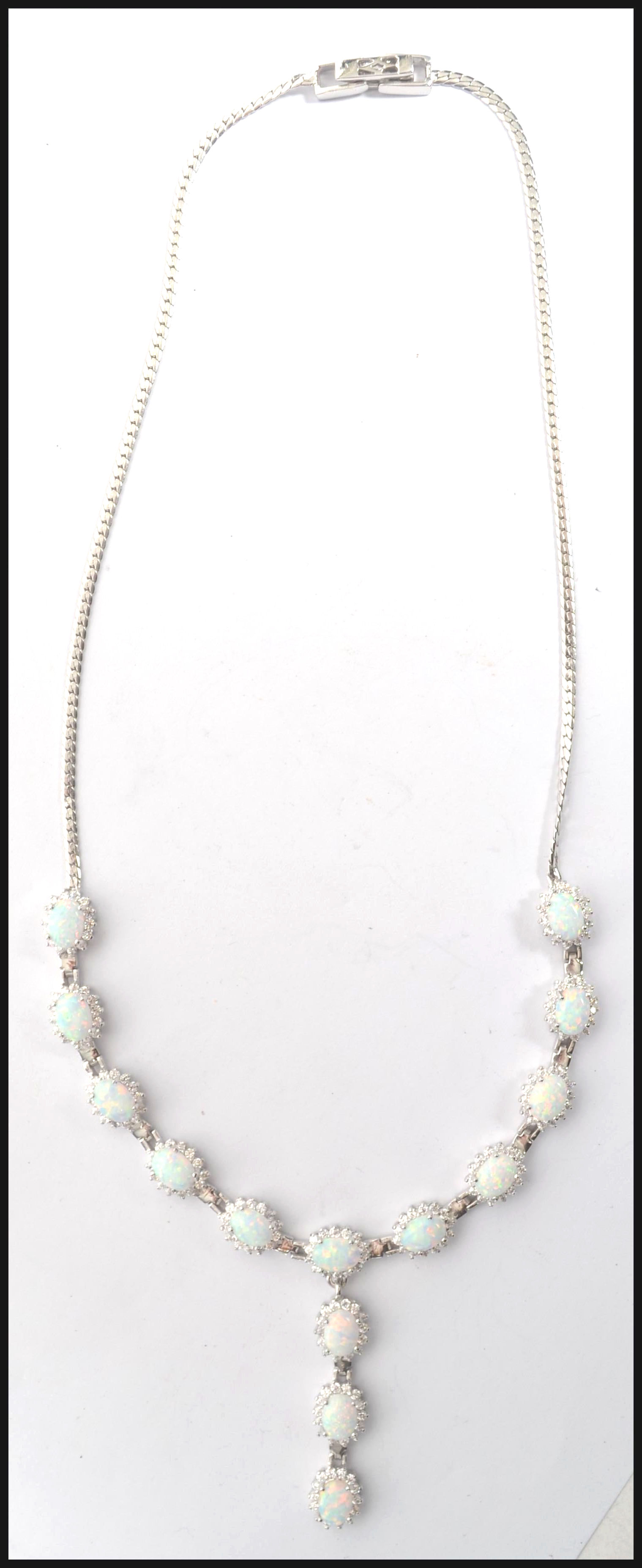 A ladies silver opal and cz adorned contemporary n