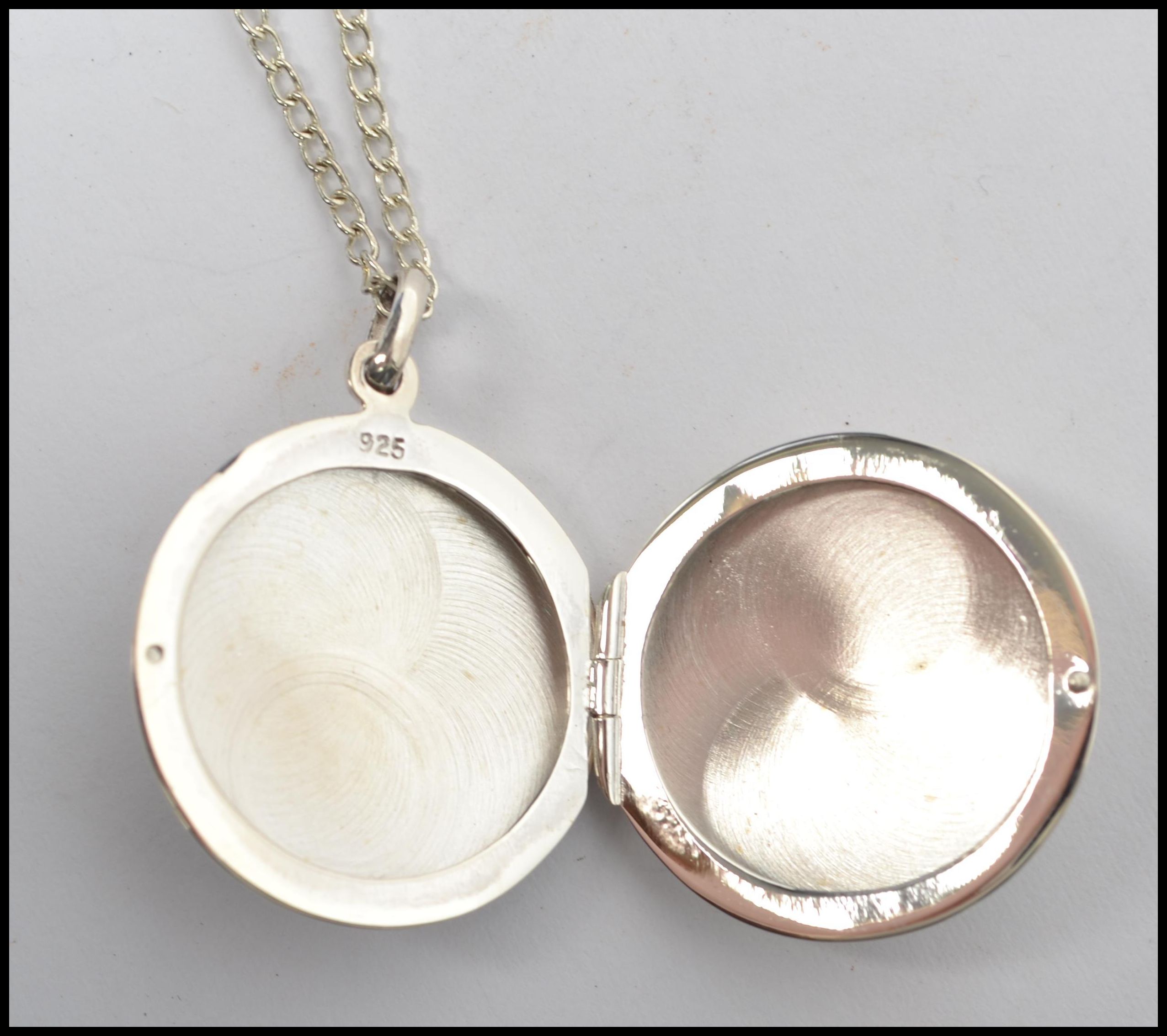 A gentleman's circular silver locket adorned with - Image 4 of 5