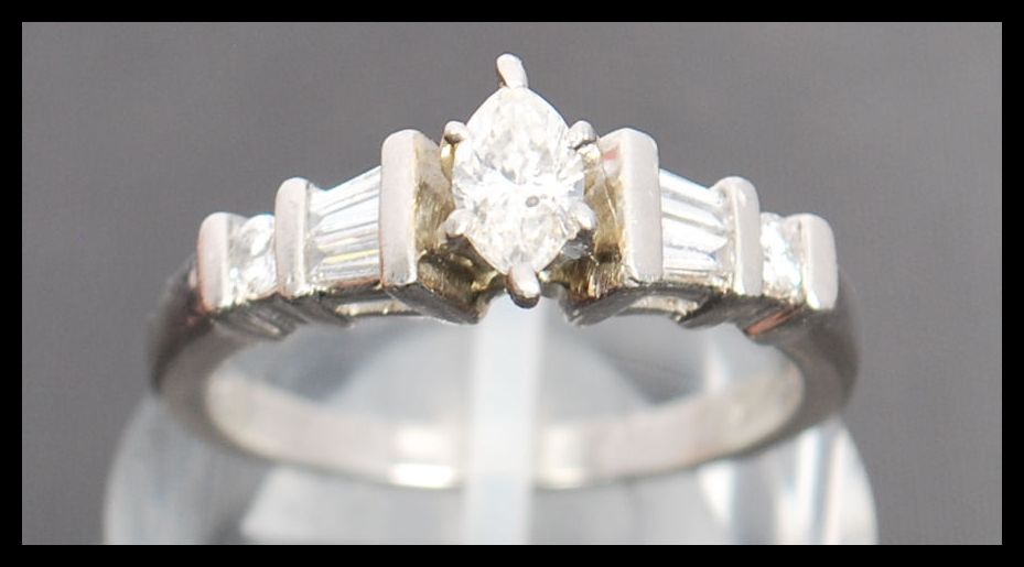 A 900 platinum and diamond ring. The ring having a