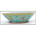 An early 20th Chinese blue ground bowl with painte