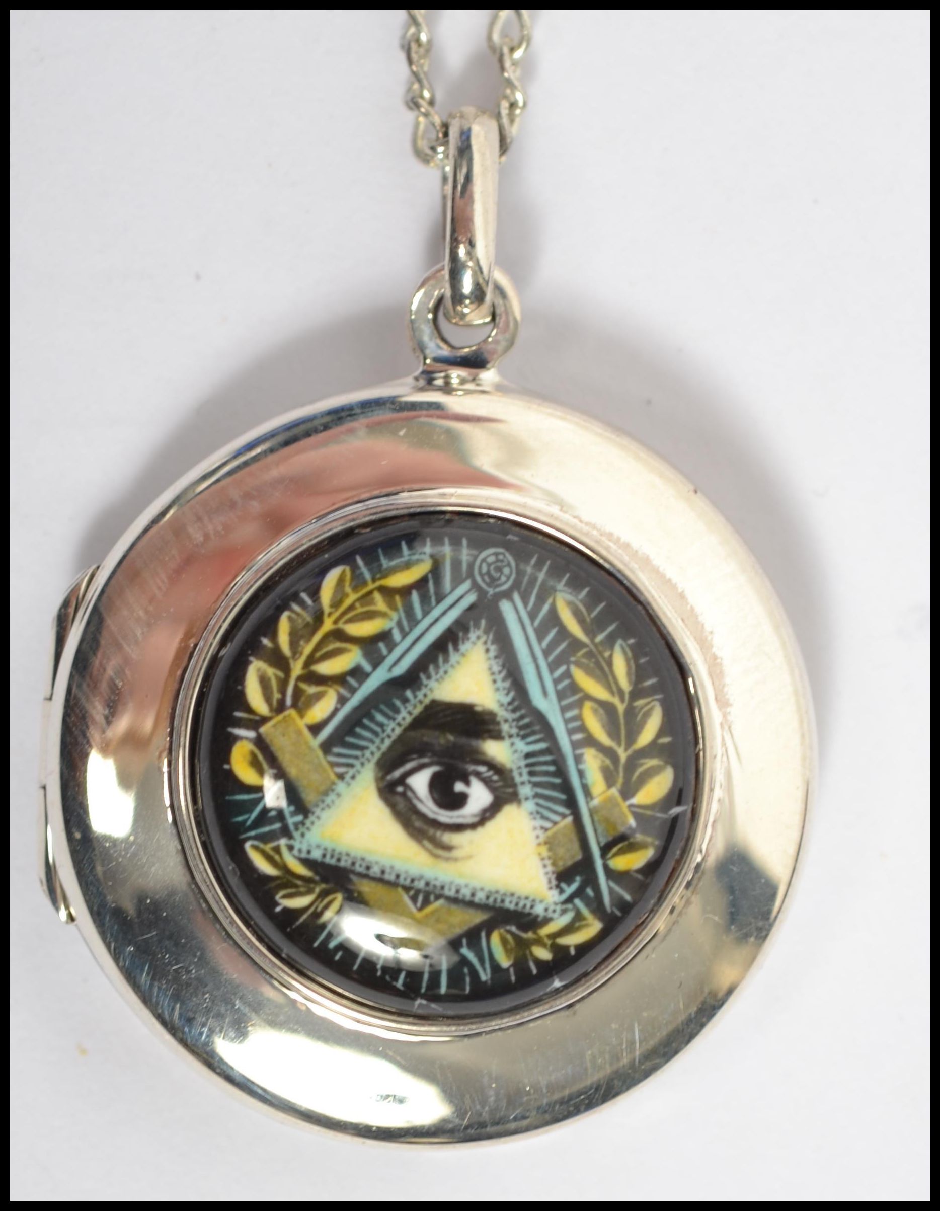 A gentleman's circular silver locket adorned with - Image 2 of 5