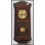 An early 20th century oak wall clock having silver