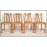 A set of four vintage 20th century Art Deco style oak dining chairs raised on block and turned