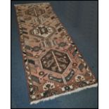 A 20th century Kelim woolen rug / runner , on red ground with a central medallion, inner border with