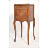 A 19th century French marble bedside cabinet having sabre legs with a cupboard under short drawer