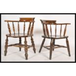 A pair of antique style Windsor - smokers bow armchairs being raised on turned legs united by