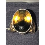 A 14ct gold diamond and citrine ring. The ring being set with a large bicolour oval citrine of green