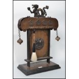 A Chinese calligraphy hard wood and copper brush stand, the stand surmounted with a cast metal