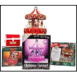 A group of three boxed Christmas toy displays to include a Classic Christmas Carousel animated