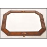 A 1920's oak framed Jacobean revival overmantel mirror with embellished frame having central