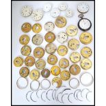 A good collection of vintage 19th and 20th century pocket watch movements, faces and dust covers,