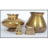 Two 18th century brass vases of baluster form along with a brass Chinese bell and figurine of a