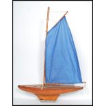 A vintage mid 20th century pond yacht having painted and varnished wood construction with brass