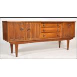 A 1970's retro teak wood sideboard being of Danish influence. Raised on tapering legs with a