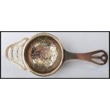 A silver hallmarked tea strainer bearing hallmarks for Birmingham. Weighs 26.6 grams. Measures 14 cm