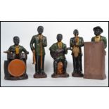 A mid 20th century 1950s five piece ceramic figures jazz band figurine group consisting of Piano,