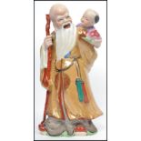 An Oriental Chinese Ceramic figurine of an elder w