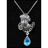 A 925 silver Art Nouveau style pendant necklace strung with a cherub bust set with emerald green,