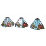 A set of three 20th century coloured stained glass leaded  light shades in the manner of Tiffany,