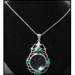 A 925 silver Art Nouveau style pendant necklace strung with an ornate magnifying glass set with