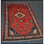 A 20th century Kelim woolen rug / carpet , on red ground with a central medallion, inner border with