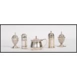 A collection of silver hallmarked table cruets, to include blue glass lined salt and pepper