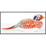 A Royal Crown Derby Pheasant paperweight, with red stamp to underside,  silver stopper, 18cm long