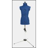A vintage 20th century retro dress makers child mannequin of adjustable form raised on a tubular