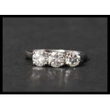 A 14ct white gold three stone diamond ring set with three diamonds in a prong setting. Diamonds