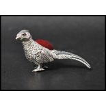 A 925 silver Victorian style pincushion in the form of a pheasant with red velvet cushion. Marked
