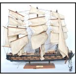 A vintage 20th century  scratch built model of a three masted galleon with sails and rigging. Raised